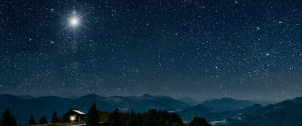 The star shines over the manger of christmas of Jesus Christ.
