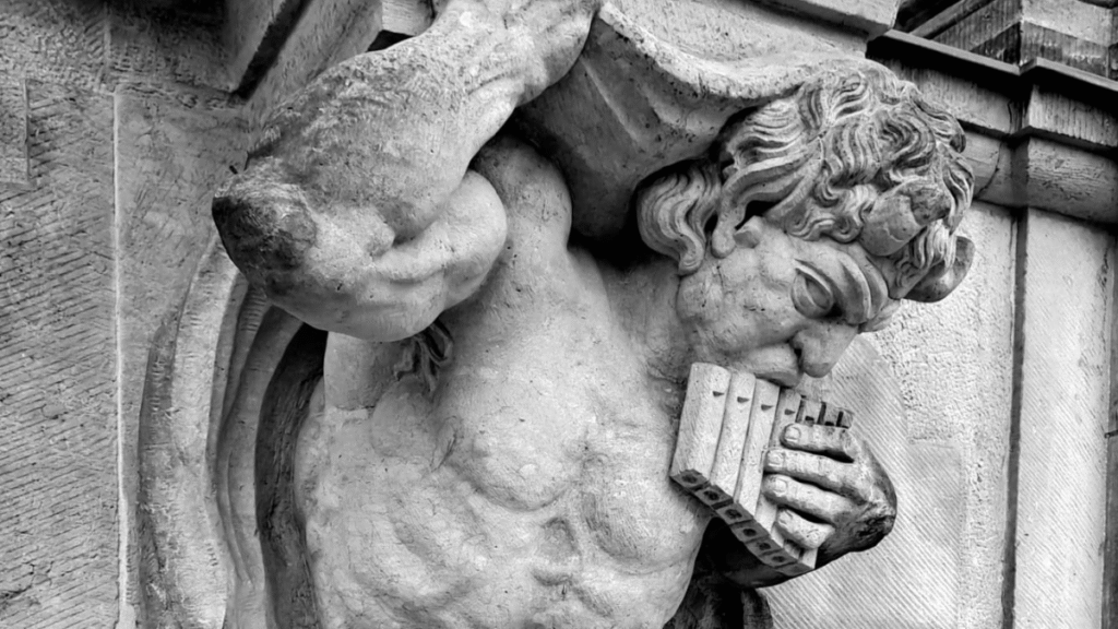 Figure playing a pan flute – symbol of the unity of body and spirit, psyche and soma in the cultures and religions of the world.